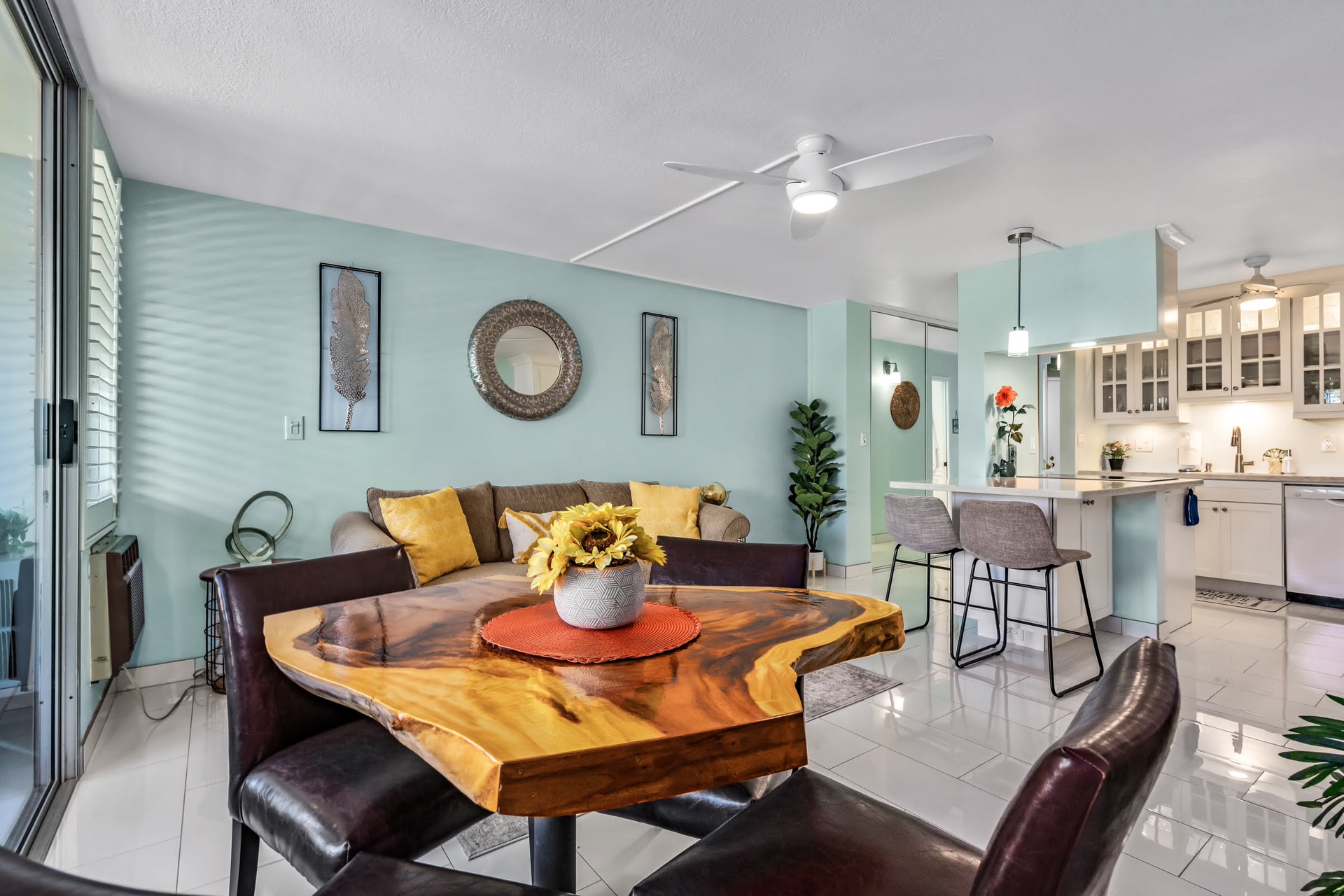 Unwind in your bright, open-concept space where soothing blue tones meet warm wood accents and a sunlit kitchen beckons—perfect for relaxing or sharing meals together.