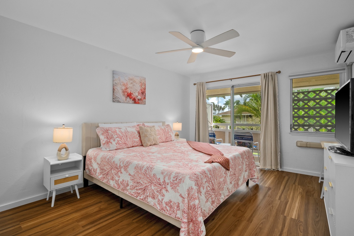 Step into your bright, airy bedroom where coral-hued linens and warm wood floors invite restful mornings. Your private lanai beckons just beyond sliding doors.