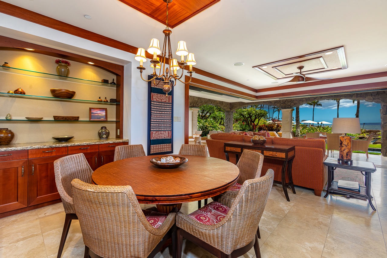 Gather around the island-inspired dining table where warm wood accents and ocean breezes set the scene for unforgettable meals with your travel companions.