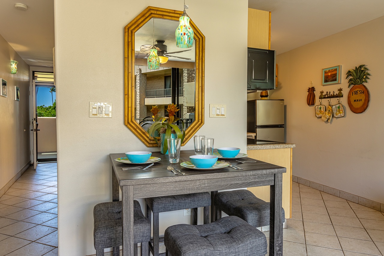 Gather around this cheerful dining nook, where vibrant turquoise bowls and playful pineapple accents set a relaxed, tropical tone for your morning coffee or evening meal.