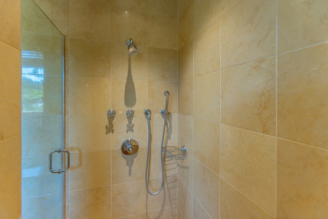 Step into your private shower oasis, where sleek tile and polished fixtures create a spa-like retreat. Dual shower options let you choose between rainfall relaxation or a handheld rinse after your adventures.