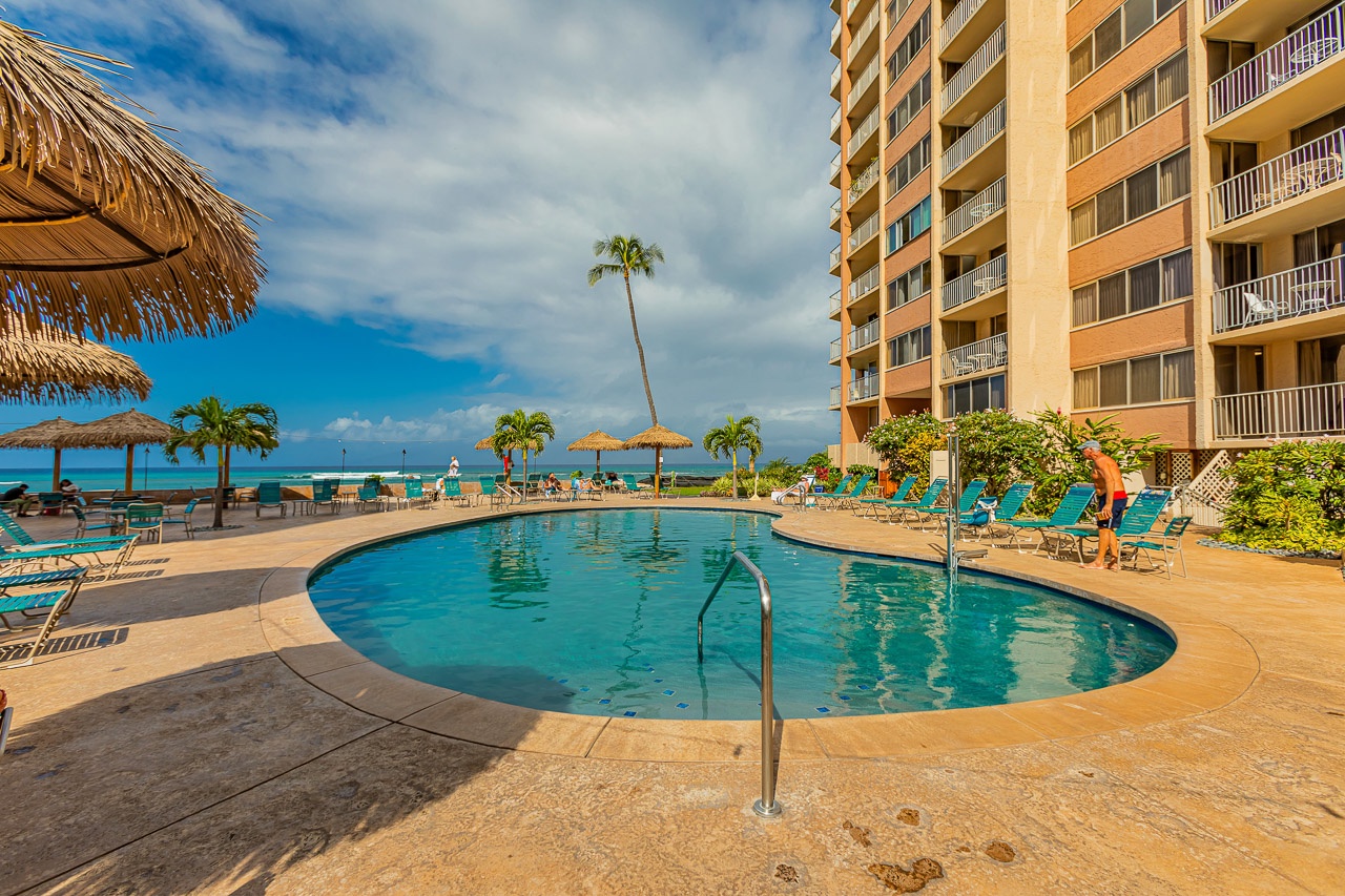 Step outside to a sparkling pool framed by swaying palms and stunning ocean views, where your tropical escape awaits just beyond the water's edge.