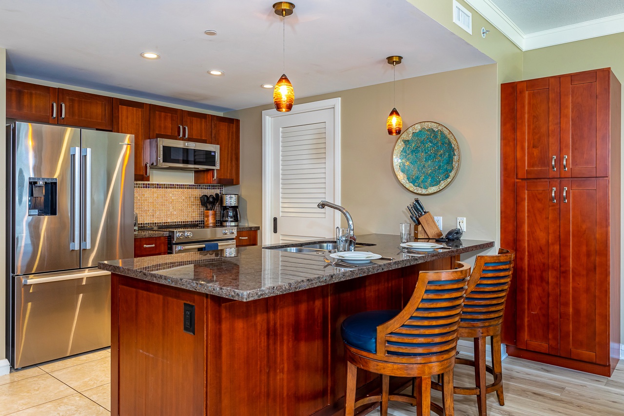 Your beautifully appointed kitchen features rich cabinetry, gleaming granite counters, and stainless steel appliances—perfect for preparing meals or enjoying a casual breakfast.