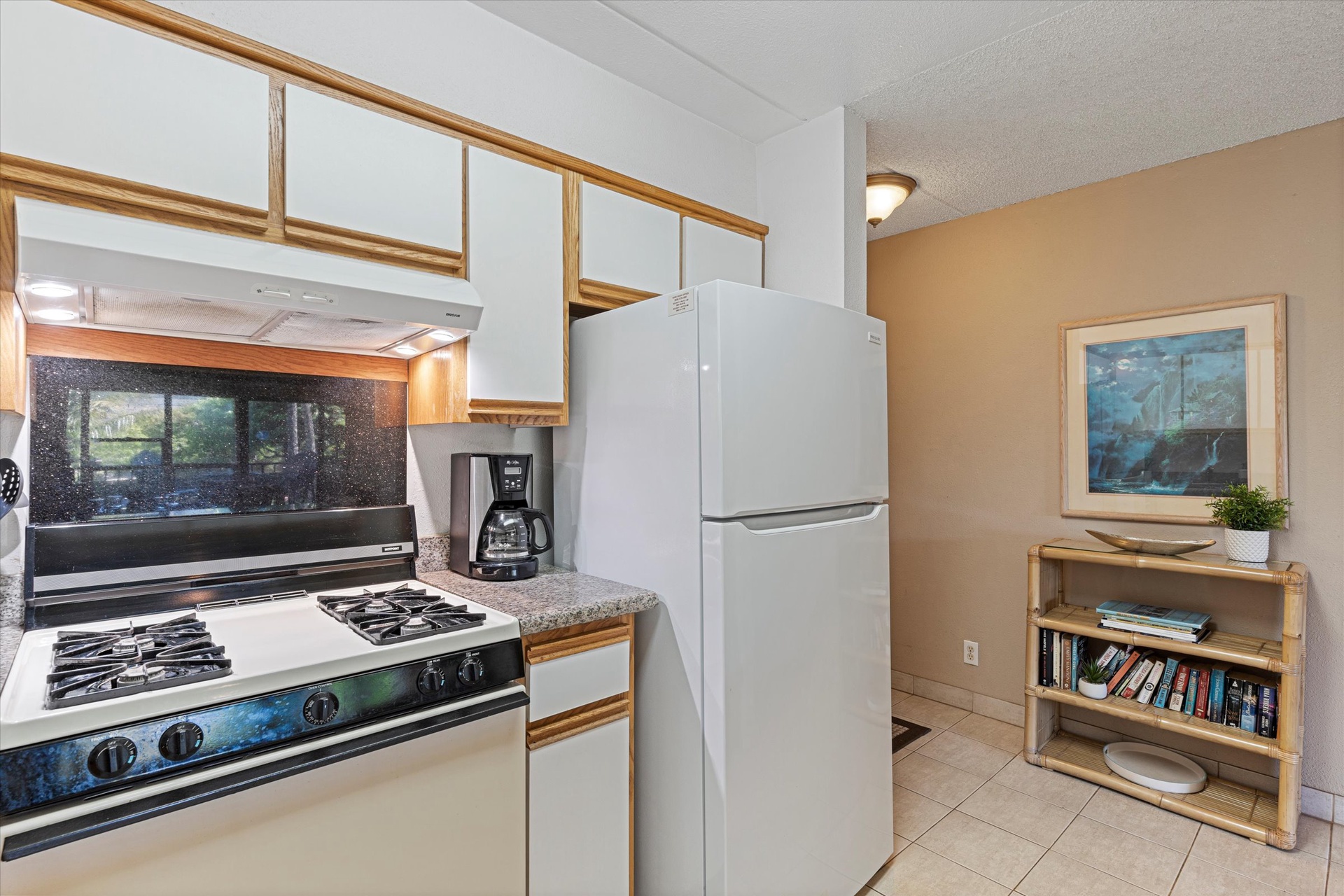 Full kitchen with stove, refrigerator, and coffee maker—everything you need to cook your favorite meals during your stay.