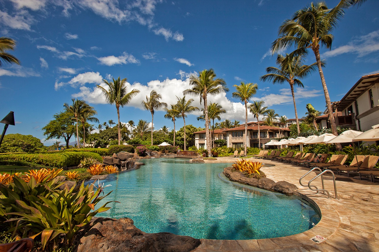 A lush lagoon-style pool surrounded by tropical palms and vibrant landscaping creates the perfect Hawaiian escape. Lounge on the sun deck and soak in the island breeze.