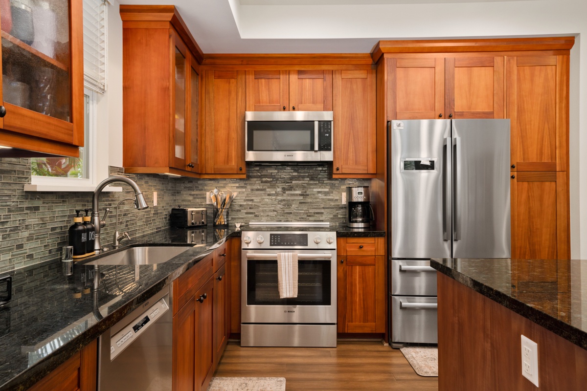 Step into your gourmet kitchen featuring rich wood cabinets, granite countertops, and stainless steel appliances where you'll love creating memorable meals.