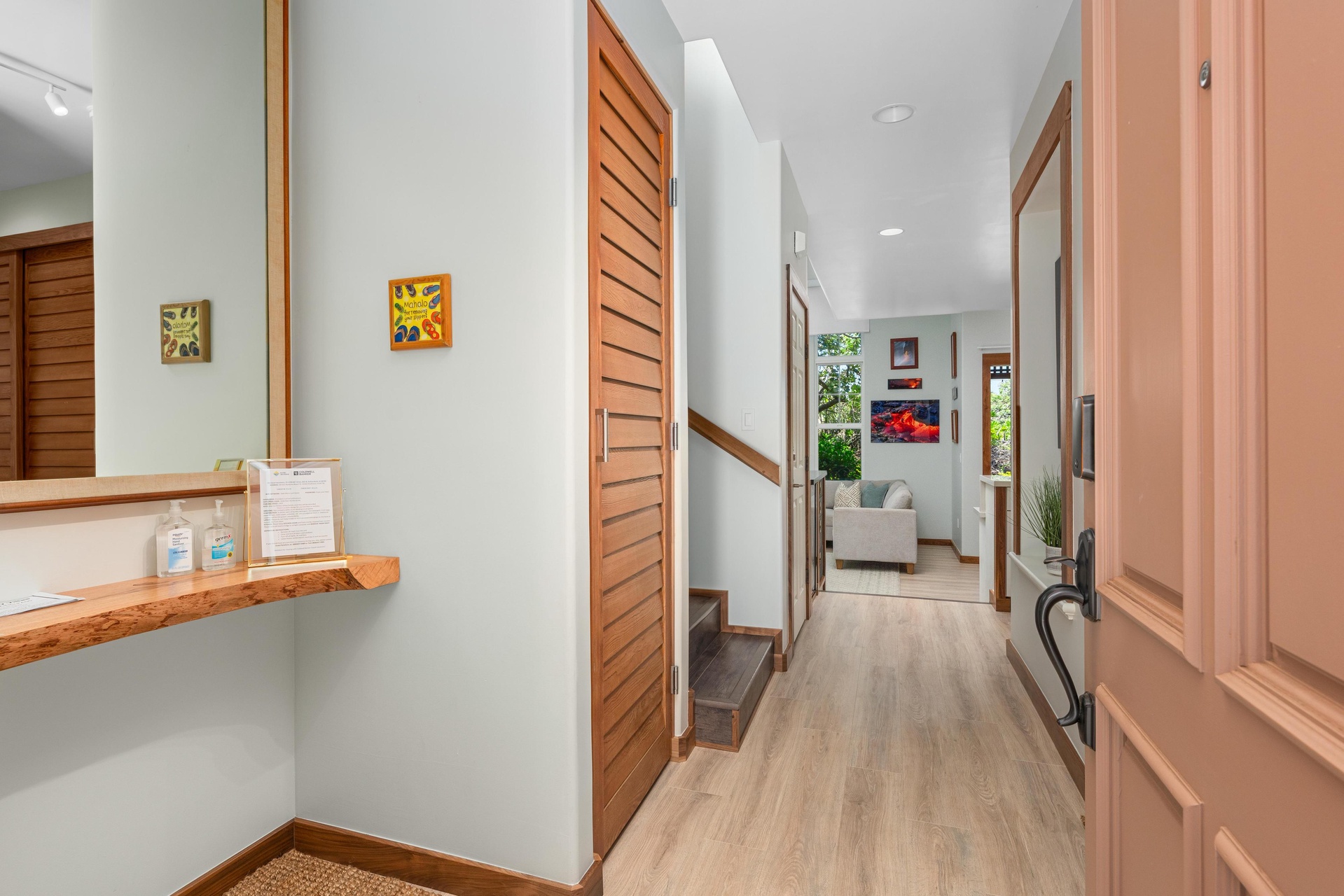 Step into your welcoming hallway where warm wood accents and cheerful artwork create an inviting path to your cozy living spaces ahead.