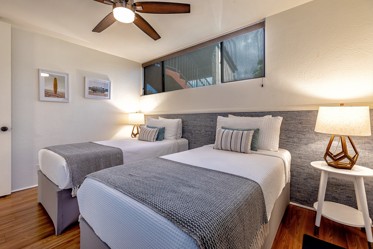 Cozy guest bedroom with windows to bring in the natural light.