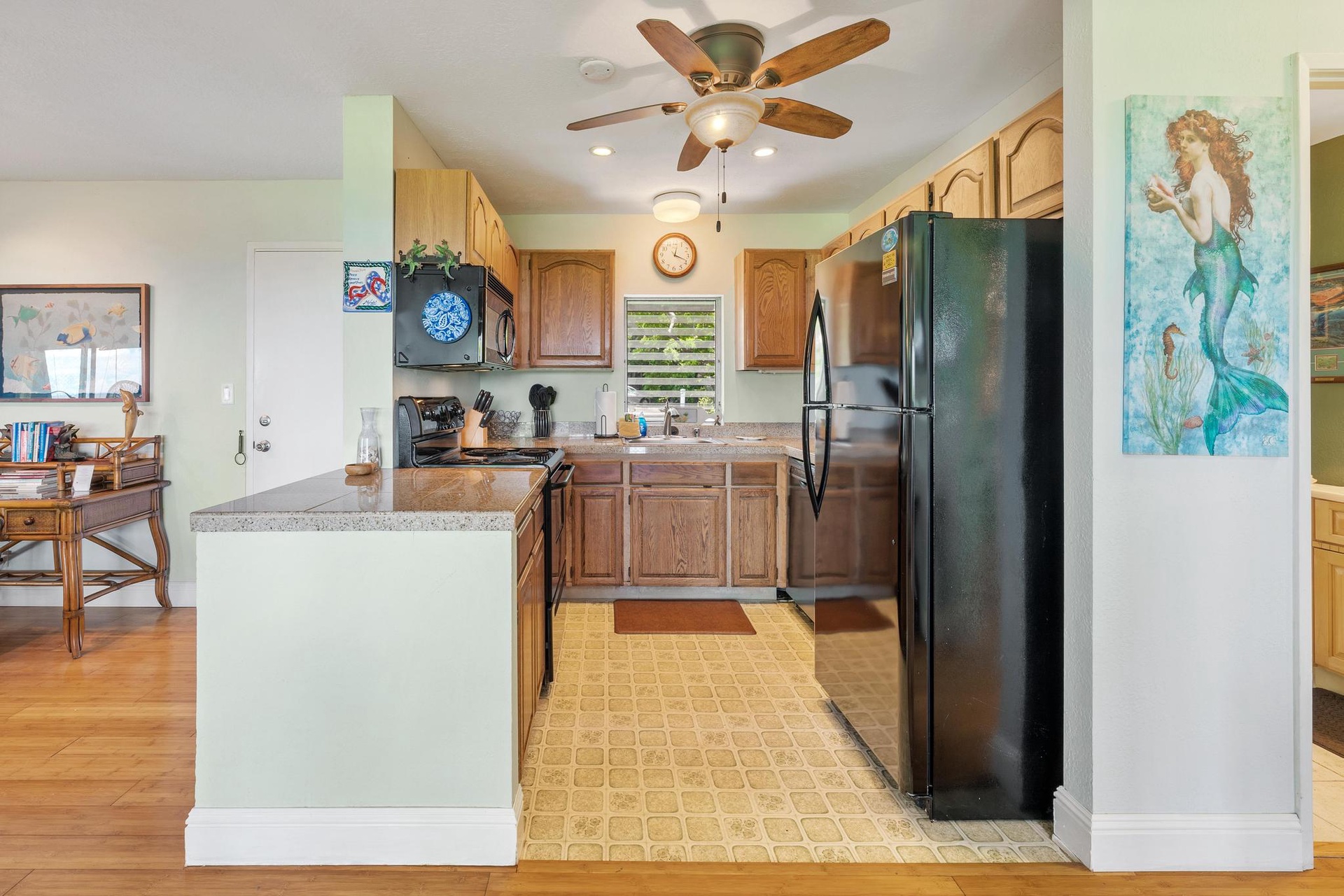 Your fully equipped kitchen awaits with stainless appliances, granite counters, and coastal charm—perfect for preparing tropical feasts together.