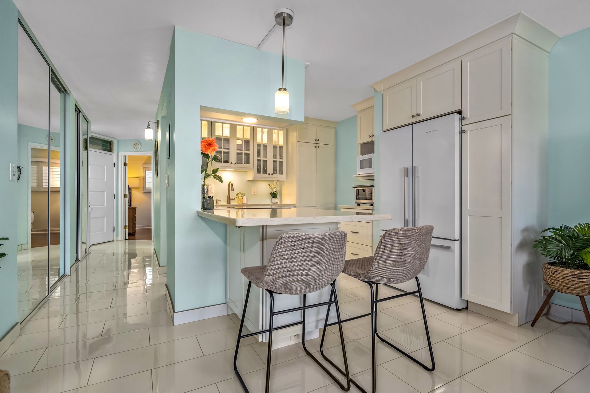 Gather around your private breakfast bar in this bright, fully equipped kitchen with modern appliances and soothing coastal colors—perfect for morning coffee or casual meals during your stay.