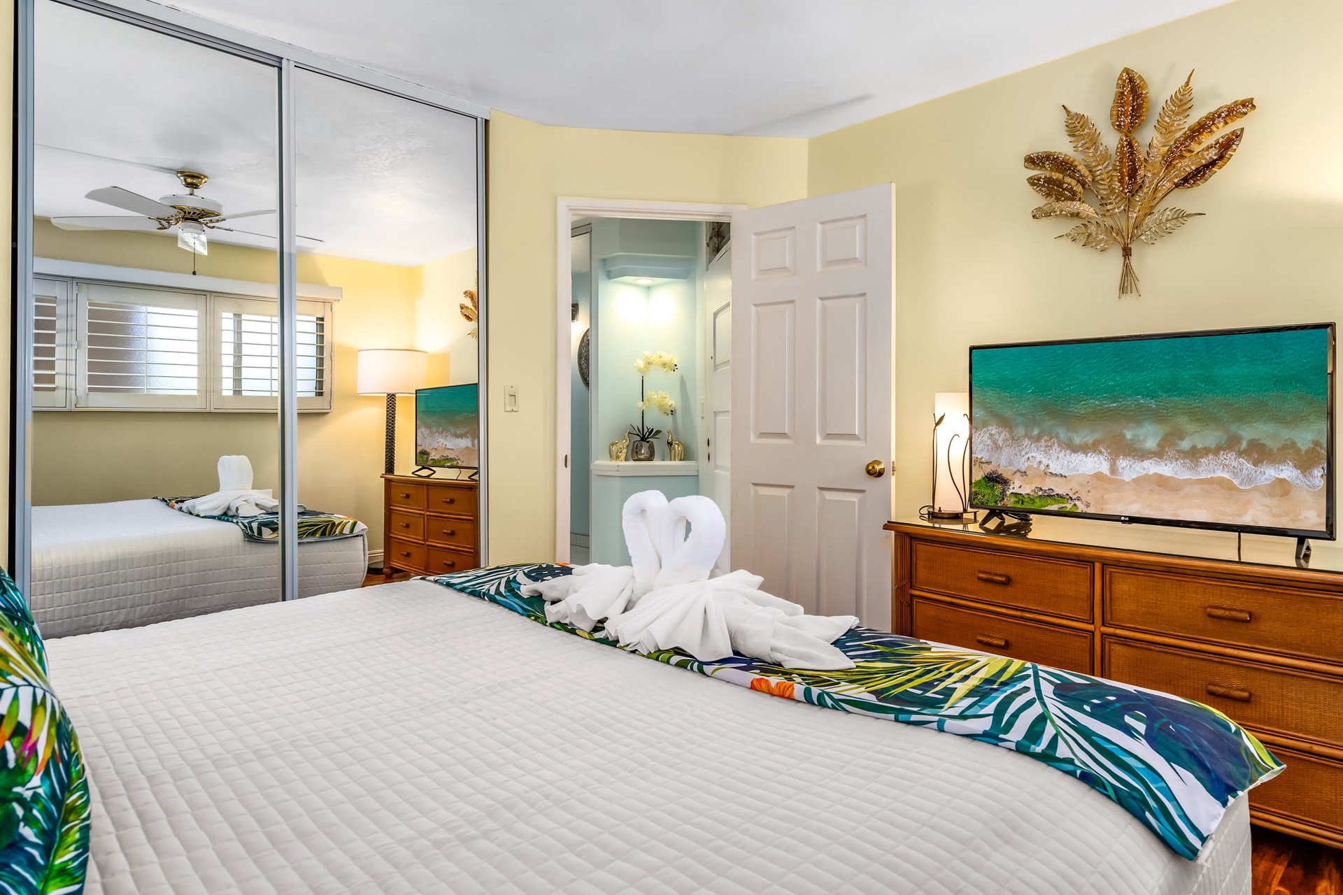Unwind in your peaceful bedroom with a plush queen bed, coastal art, and mirrored closets. Soft yellow walls and tropical touches make this your tranquil island retreat.