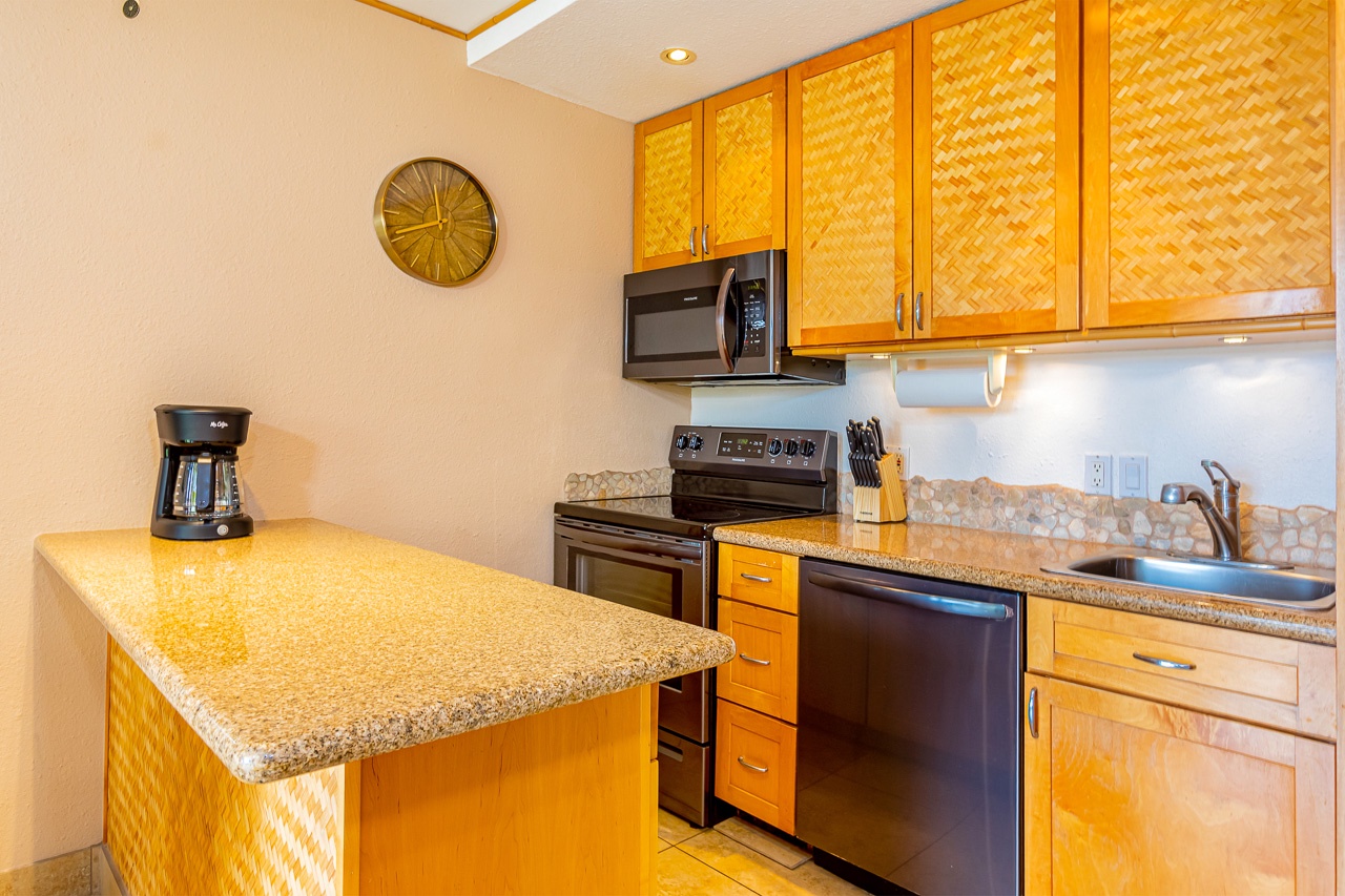 Your tropical-inspired kitchen features warm woven cabinetry, granite counters, and a convenient breakfast bar for morning coffee.