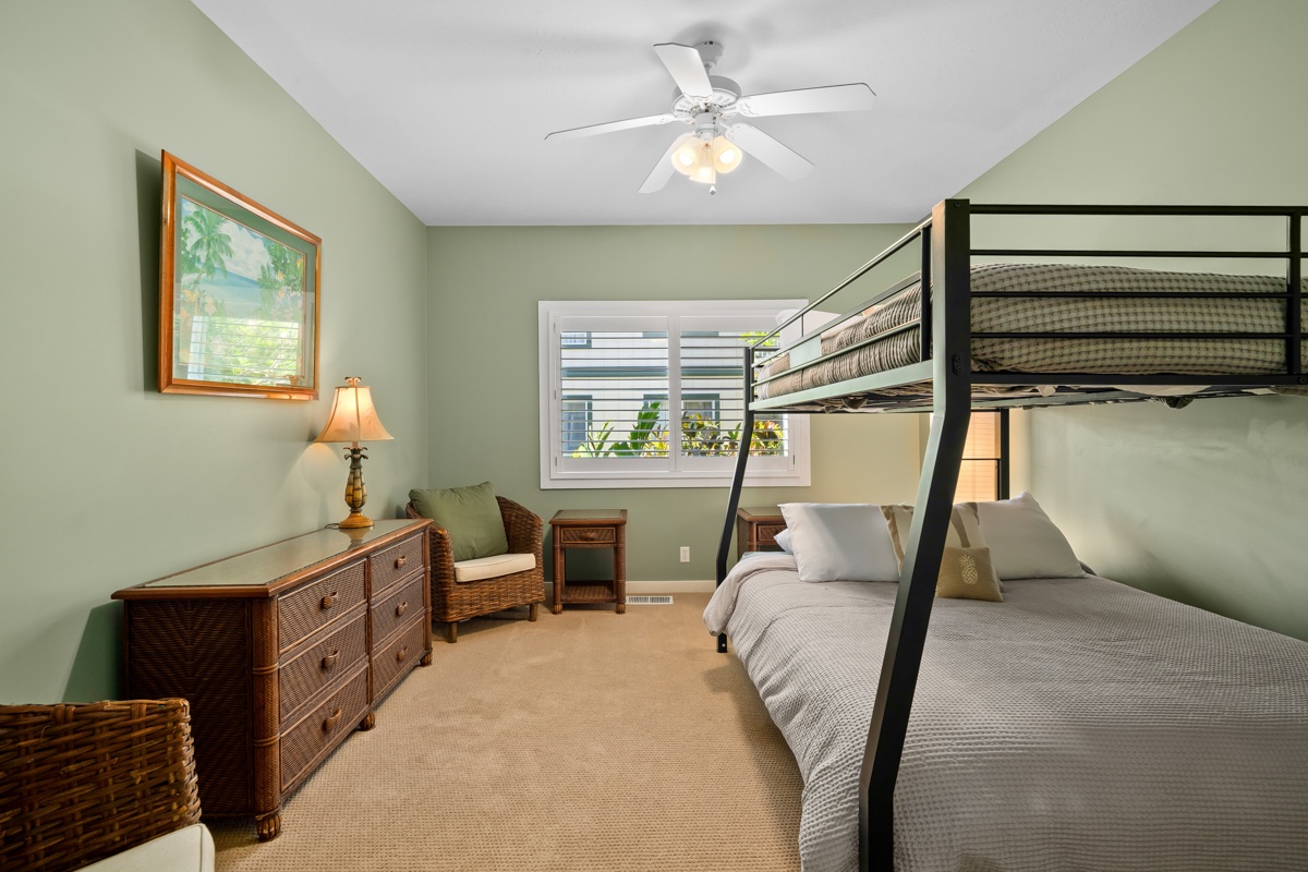 Your peaceful retreat features wicker furnishings, and a bunk bed setup for families. Enjoy comfort with a ceiling fan, soft lighting.
