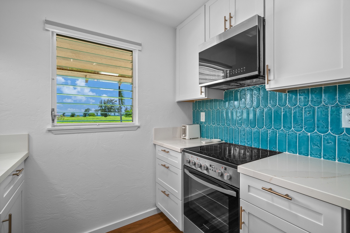 Step into your fully equipped kitchen featuring stunning turquoise tile backsplash and modern appliances,