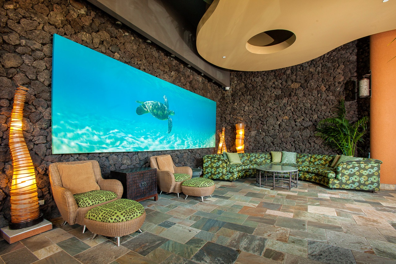 Sink into plush seating while mesmerized by the stunning underwater display—your tropical escape awaits in this spectacular lounge.