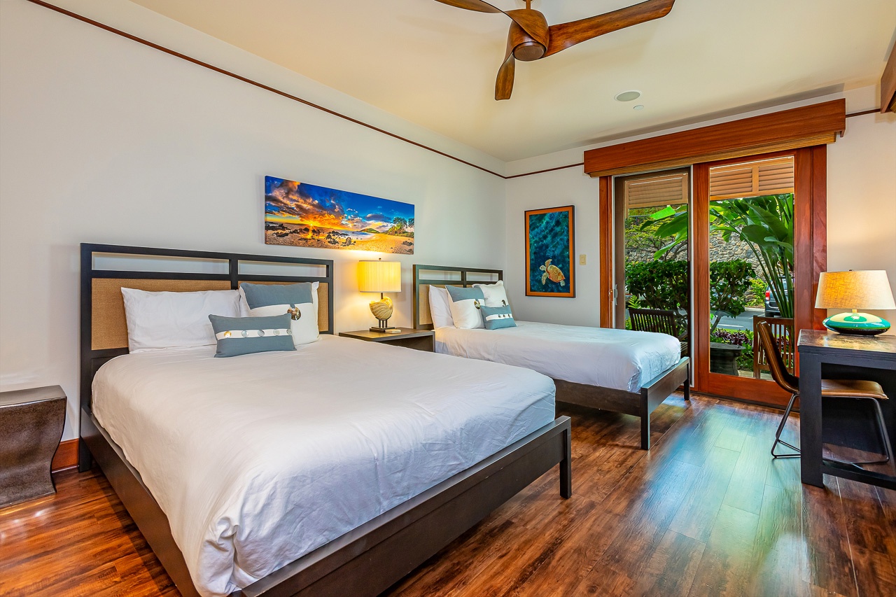 You'll drift off beneath a gently turning ceiling fan while lush tropical greenery frames your view through elegant wood-trimmed doors, creating a soothing garden retreat just steps from your beds.