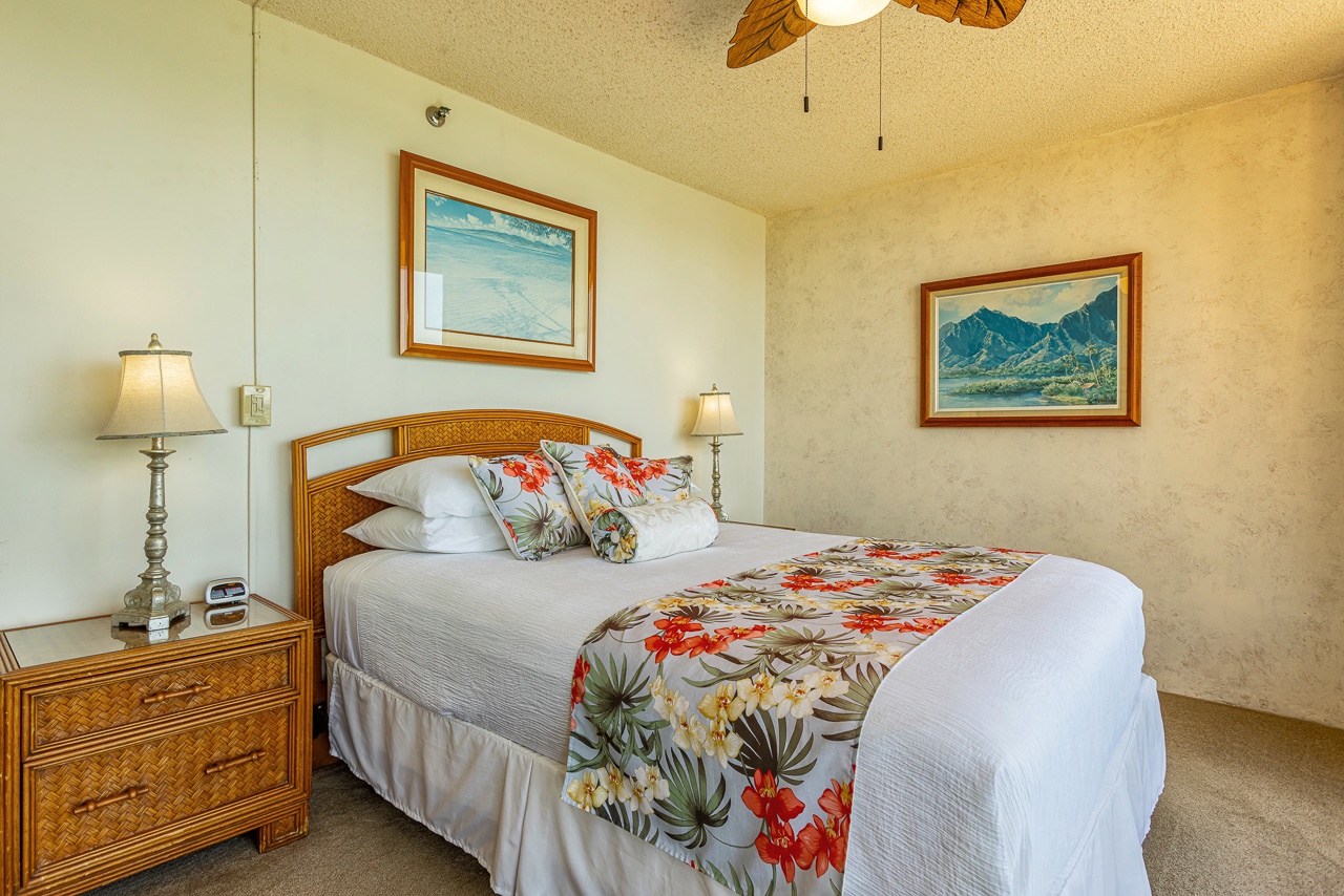 Your cozy island-inspired bedroom awaits with tropical bedding, warm lighting, and a ceiling fan to keep you comfortable during your stay.