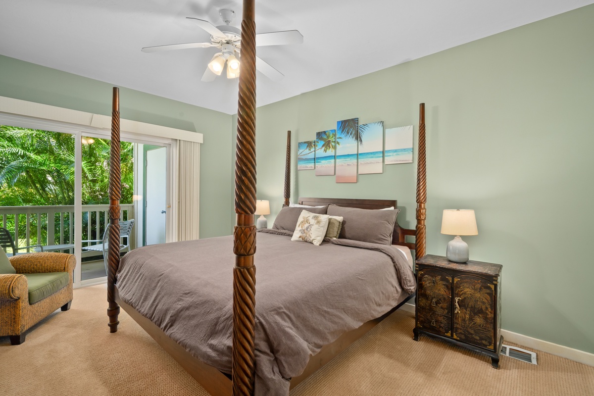 Drift off in your coastal-inspired bedroom featuring a statement four-poster bed with twisted wood posts and tropical garden views from your private balcony.