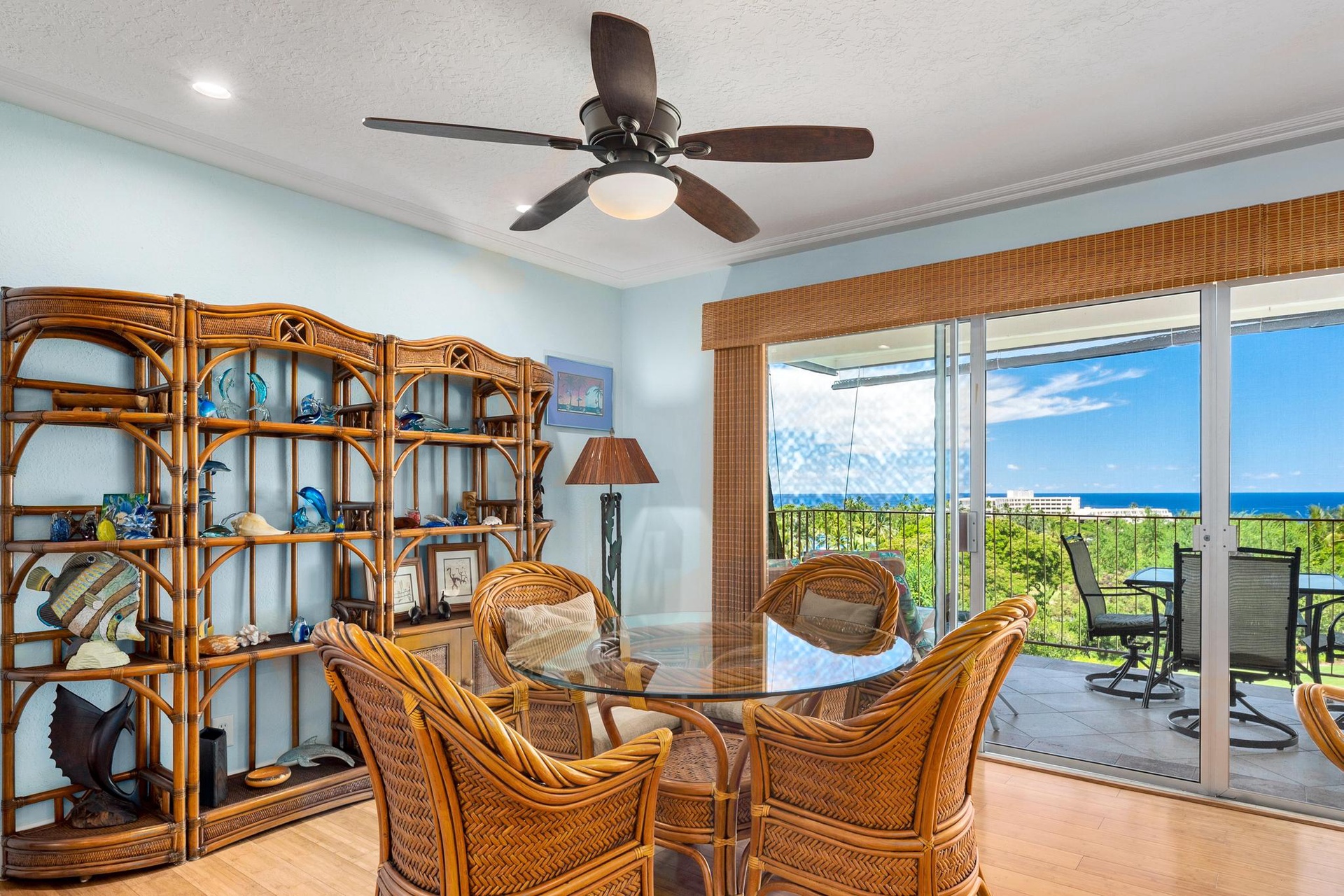 Unwind in your tropical-inspired dining space with ocean views and a refreshing ceiling fan overhead to keep you cool.