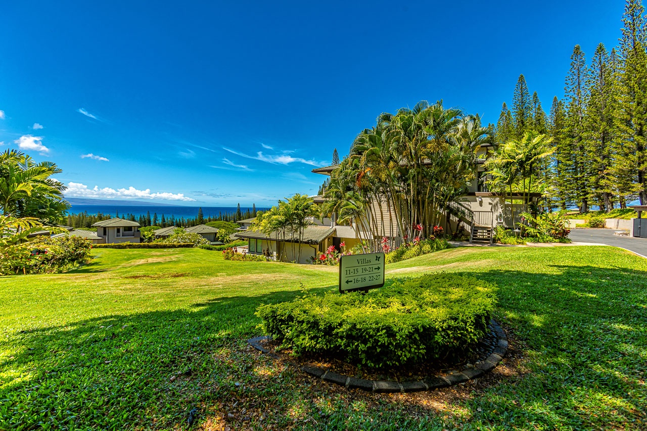 A tropical resort community features lush grounds, ocean vistas, and abundant greenery, offering an idyllic Hawaiian setting for your island retreat.