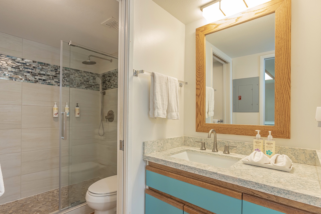 Well-lit bathroom with sleek surfaces and neutral tones