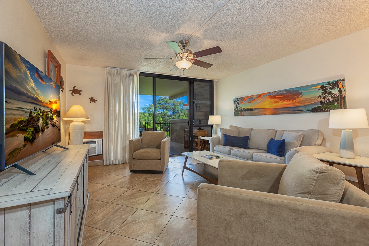 Unwind in your coastal-inspired living room, where plush seating and ocean-themed artwork invite you to relax after a day of adventure. Step out to your private balcony and soak in the tropical surroundings.