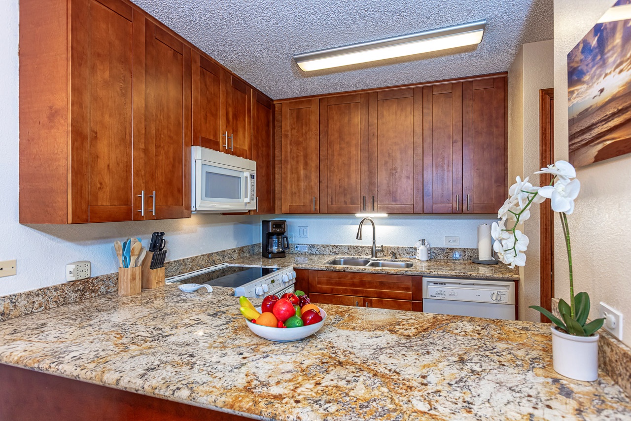 Prepare your favorite meals on sleek granite counters in this fully equipped kitchen, complete with modern appliances and everything you need for comfortable coastal living.