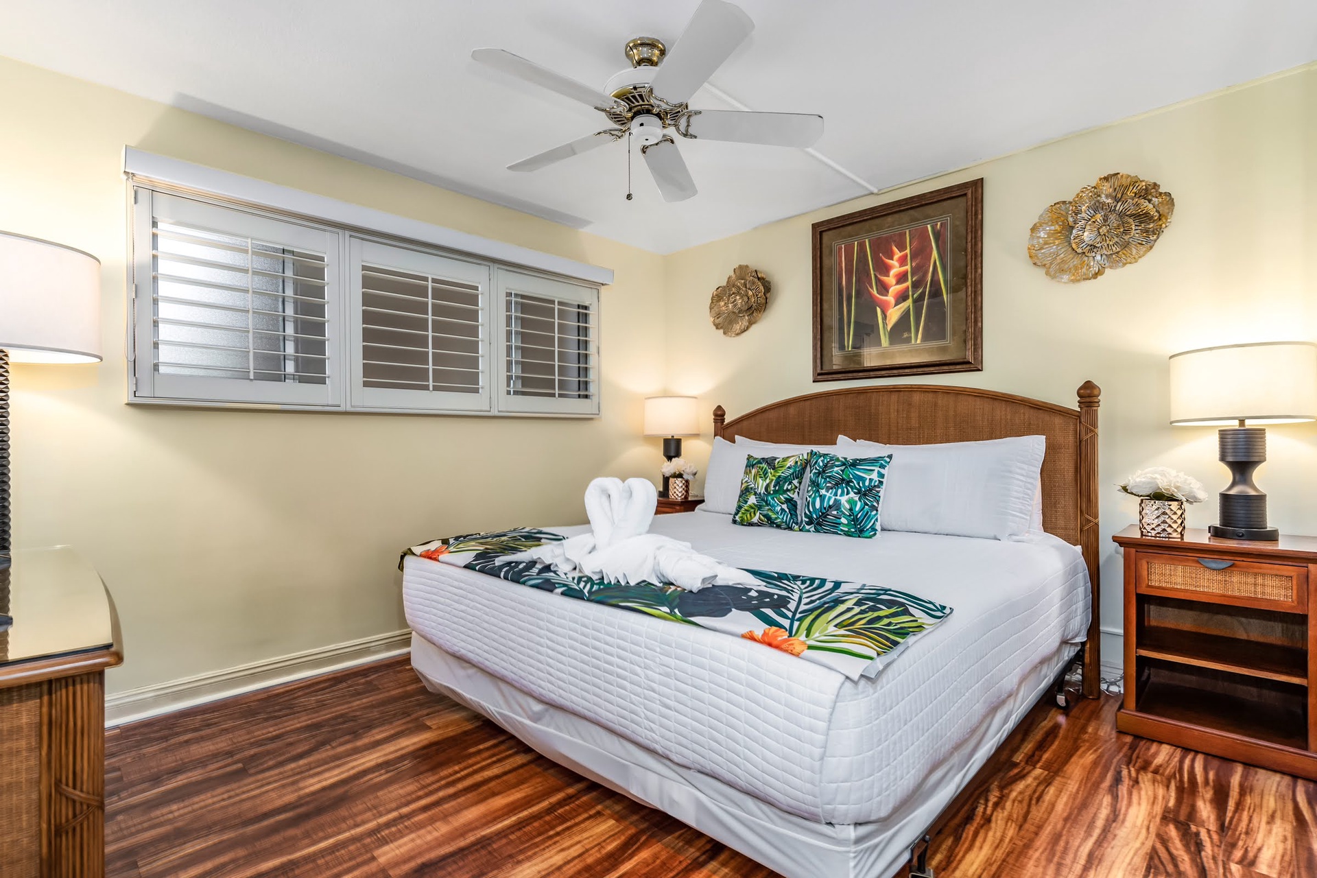 Step into your island-style bedroom with plush bedding, tropical touches, and gentle ceiling fan breezes creating your perfect retreat for restful nights.