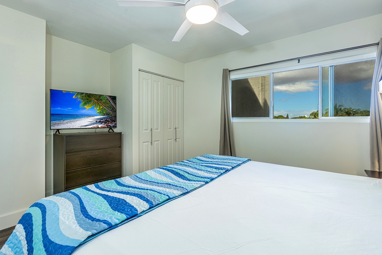 Smart TV and coastal décor create a comfy bedroom retreat