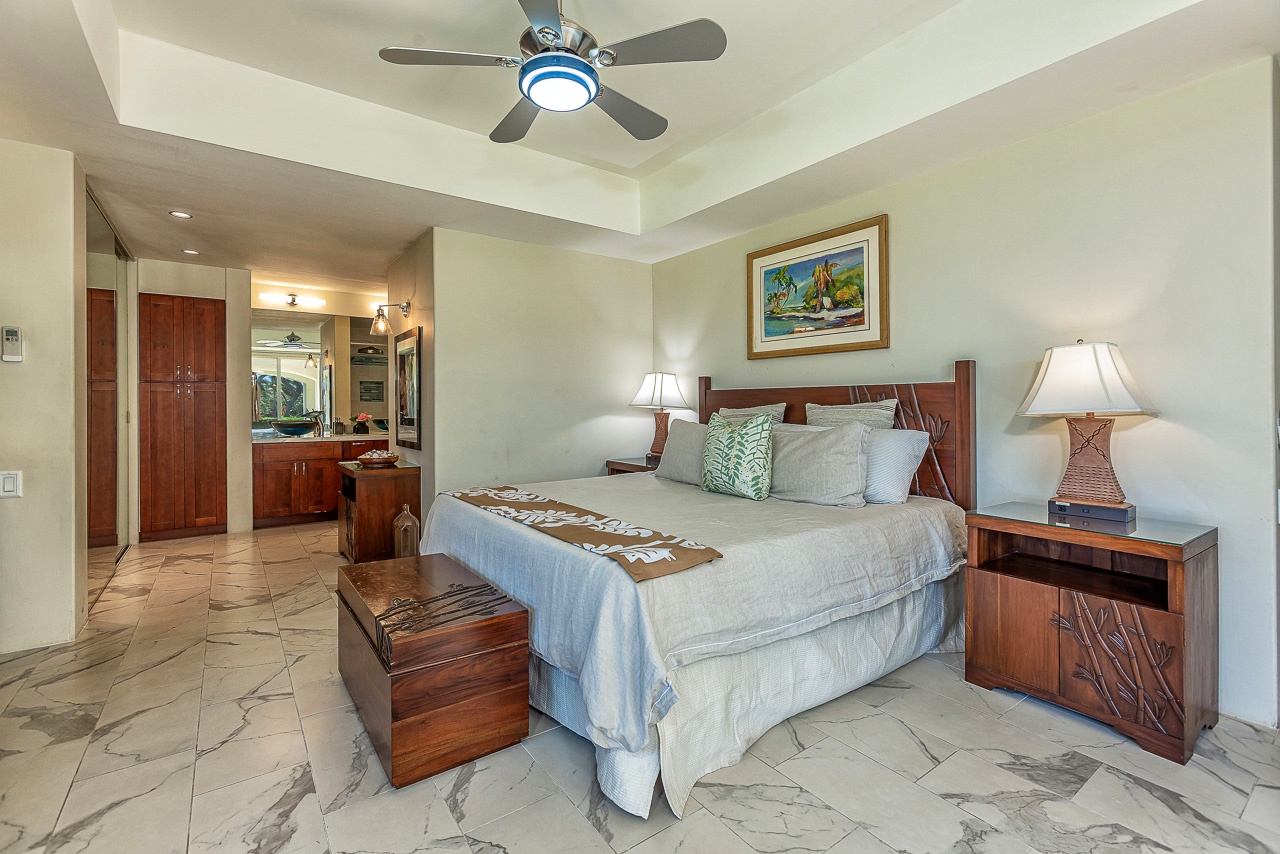 Picture yourself unwinding in your elegant bedroom, where rich wood furnishings and soft lighting create a serene island-inspired retreat. Coastal artwork and plush bedding await your arrival.