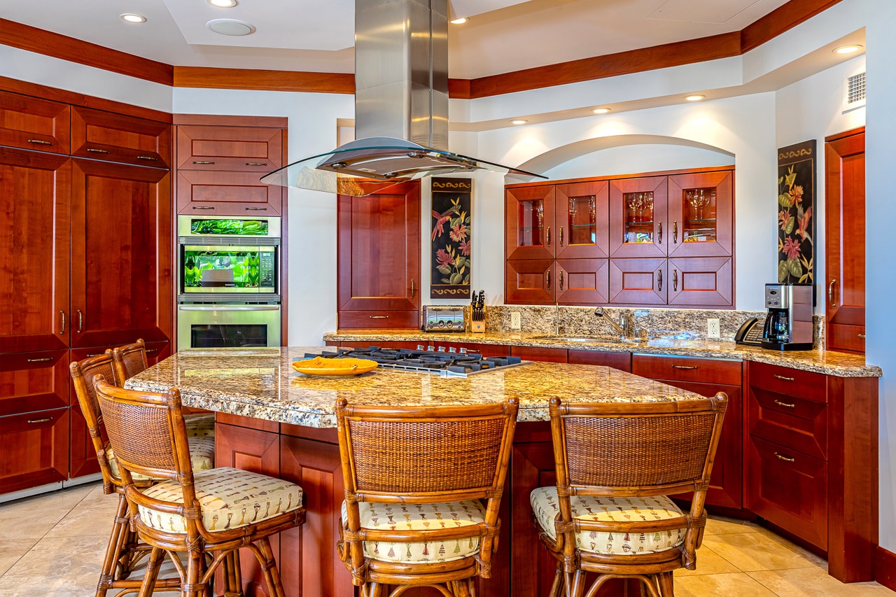 Your gourmet kitchen features stunning granite countertops, rich wood cabinetry, and a spacious island perfect for meal prep or casual dining with friends and family.