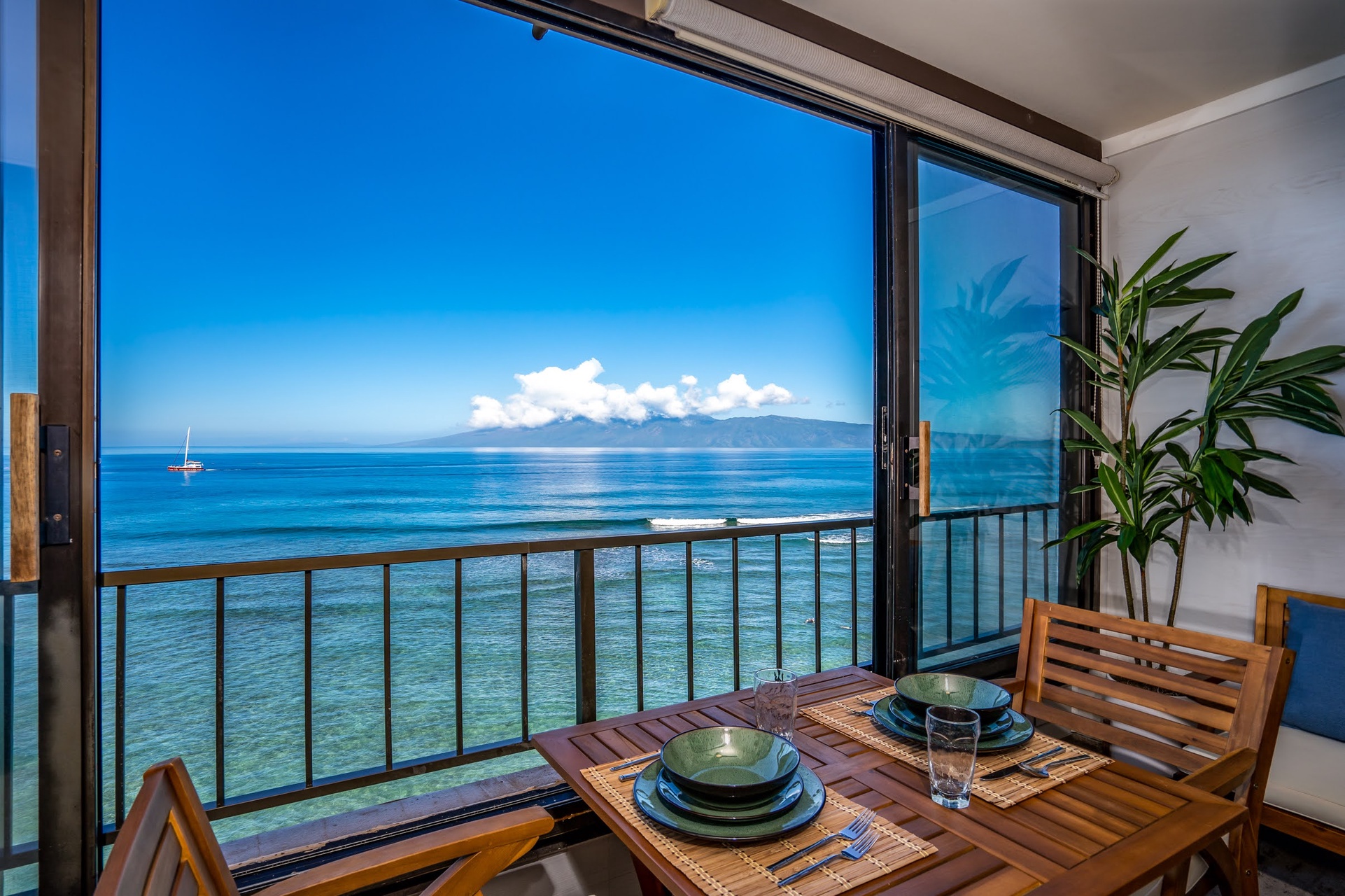Start your morning at this inviting dining nook, where vibrant ocean hues and distant island views frame each meal, making every bite feel like a tropical escape.