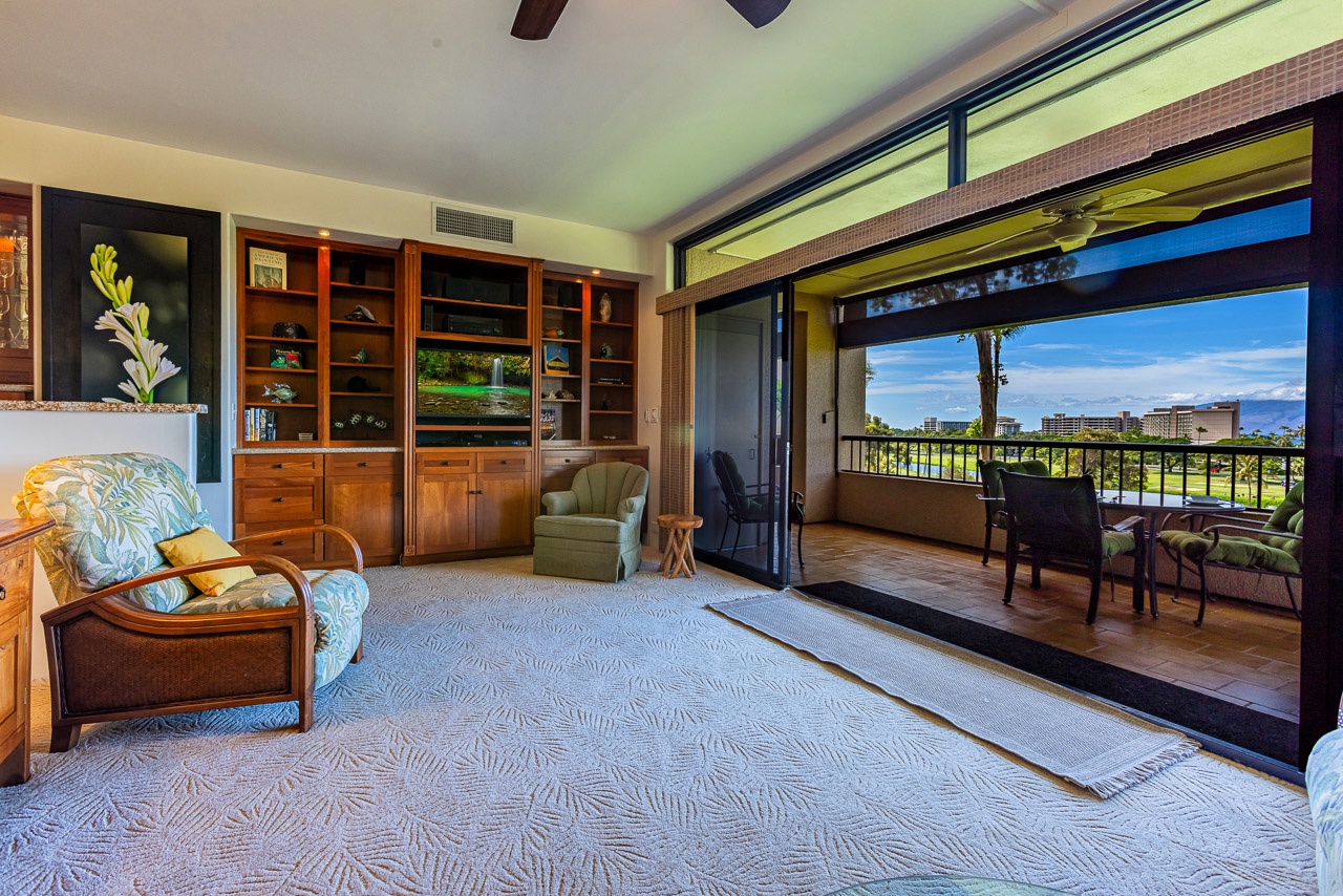 Step into your bright living room where tropical breezes flow through open lanai doors.