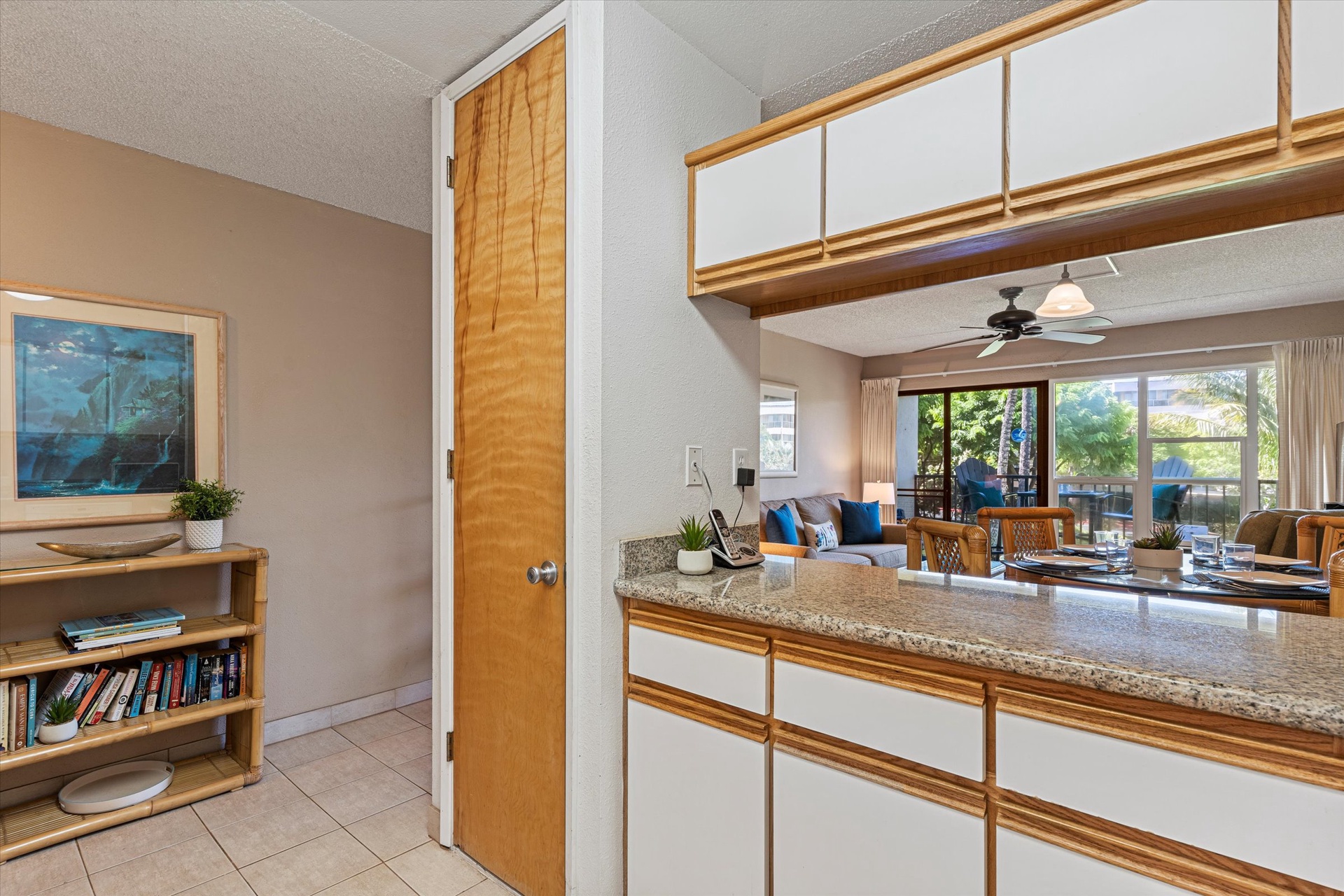 Sunlight pours through the sliding glass doors, illuminating your open-concept living space where the kitchen, dining, and lounge flow seamlessly together—perfect for relaxing or entertaining.