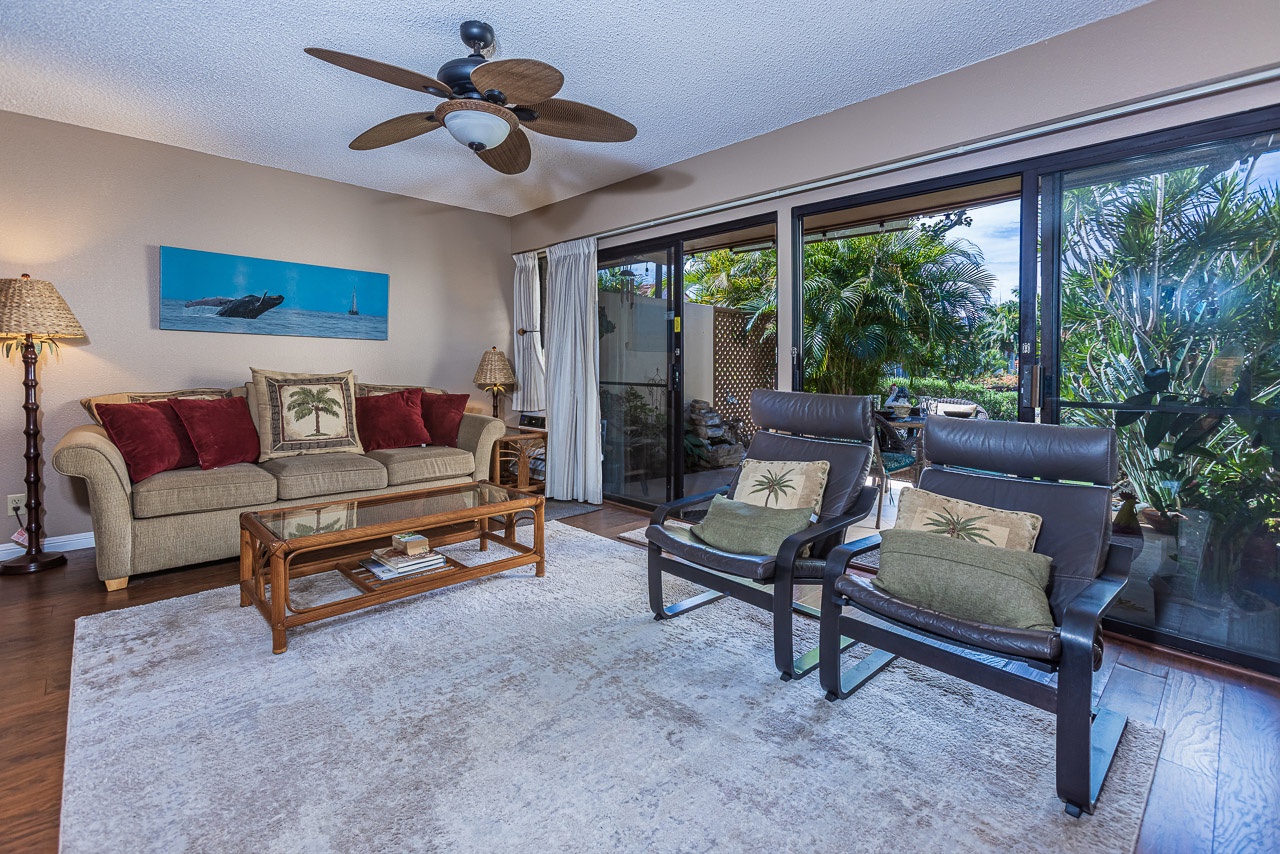 Relax in your tropical living room where comfortable seating, tropical breezes, and lush garden views create the perfect island getaway atmosphere.