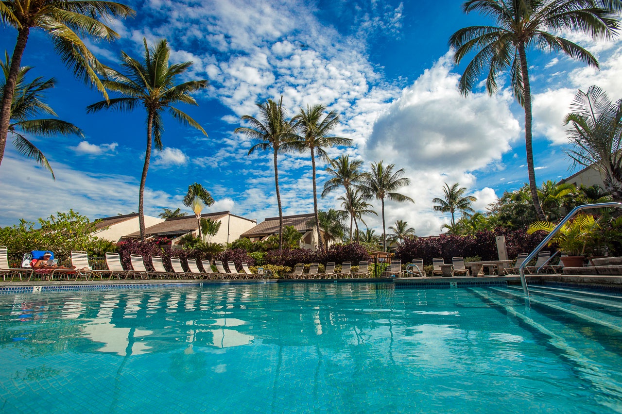 Two resort pools surrounded by lush tropical landscaping
