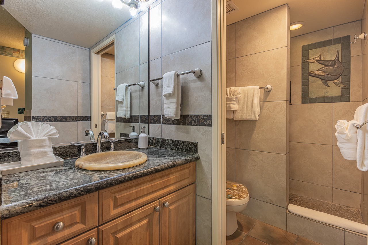 Clean, updated bathroom with elegant tile finishes