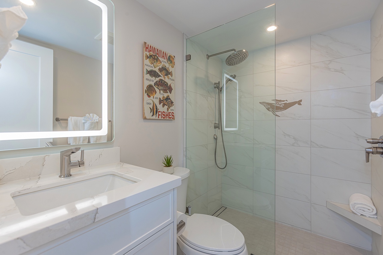 Walk in shower and lighted mirror highlight this fresh space
