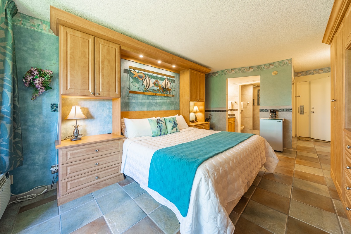 Sink into soft linens and ocean-inspired décor. Your coastal retreat awaits with soothing blue hues, custom cabinetry, and warm lighting for restful nights.