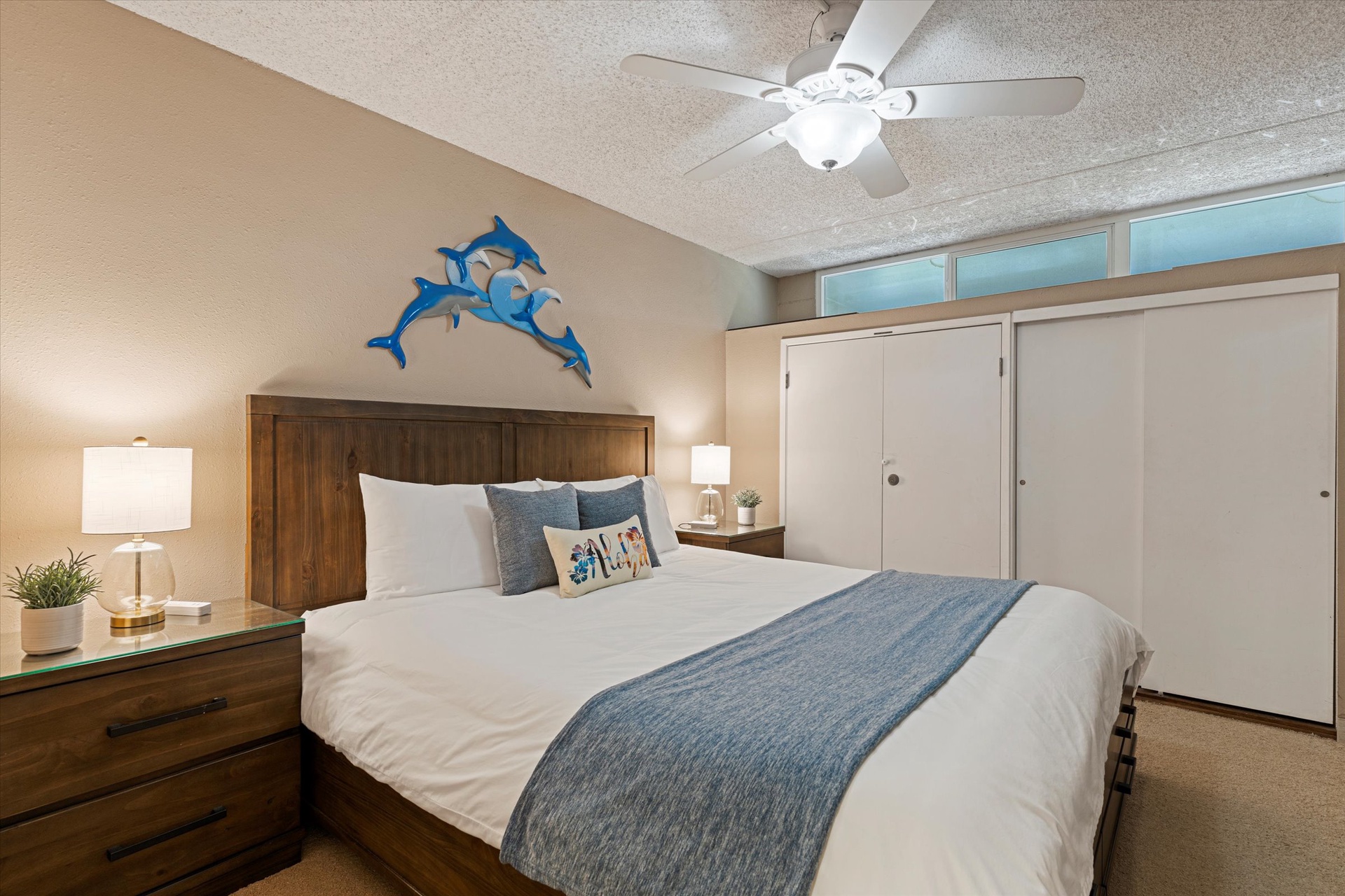 Sink into the plush white linens and let the ocean-inspired decor calm your mind. Your peaceful retreat features bedside lamps, ample storage, and a ceiling fan to keep you comfortable all night.
