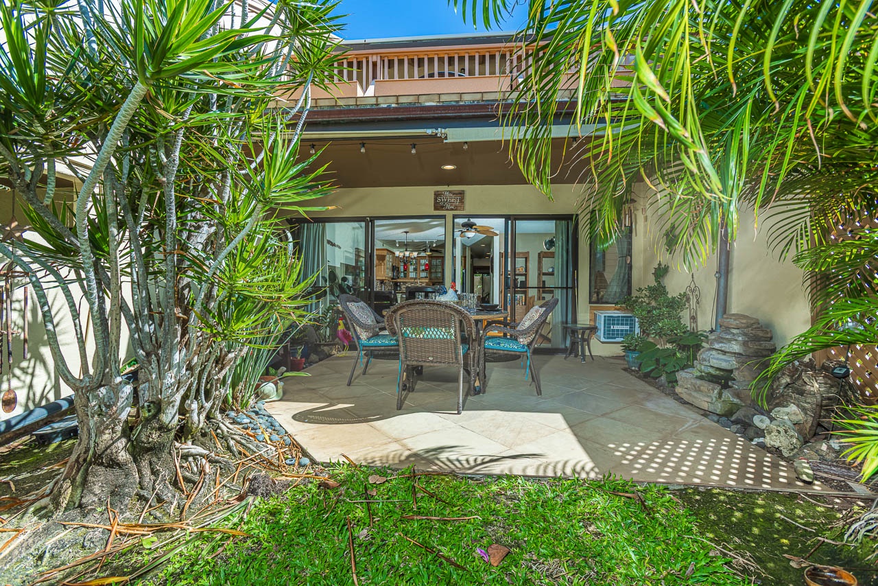 Out on the tropical sanctuary where lush palms frame your private lanai, perfect for morning coffee or evening relaxation.