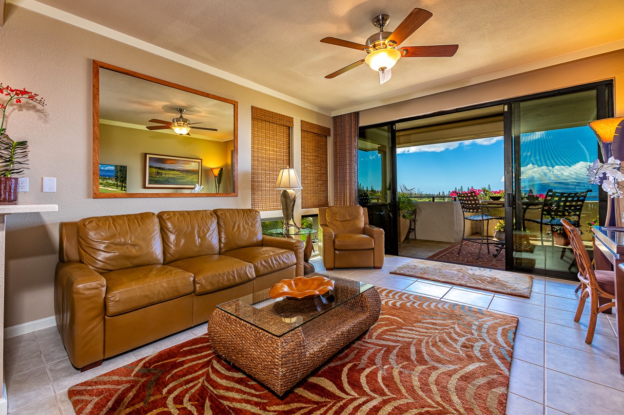 Relax in your inviting living space with a plush leather sofa, stylish tropical décor, and a private balcony opening to ocean views and island breezes.