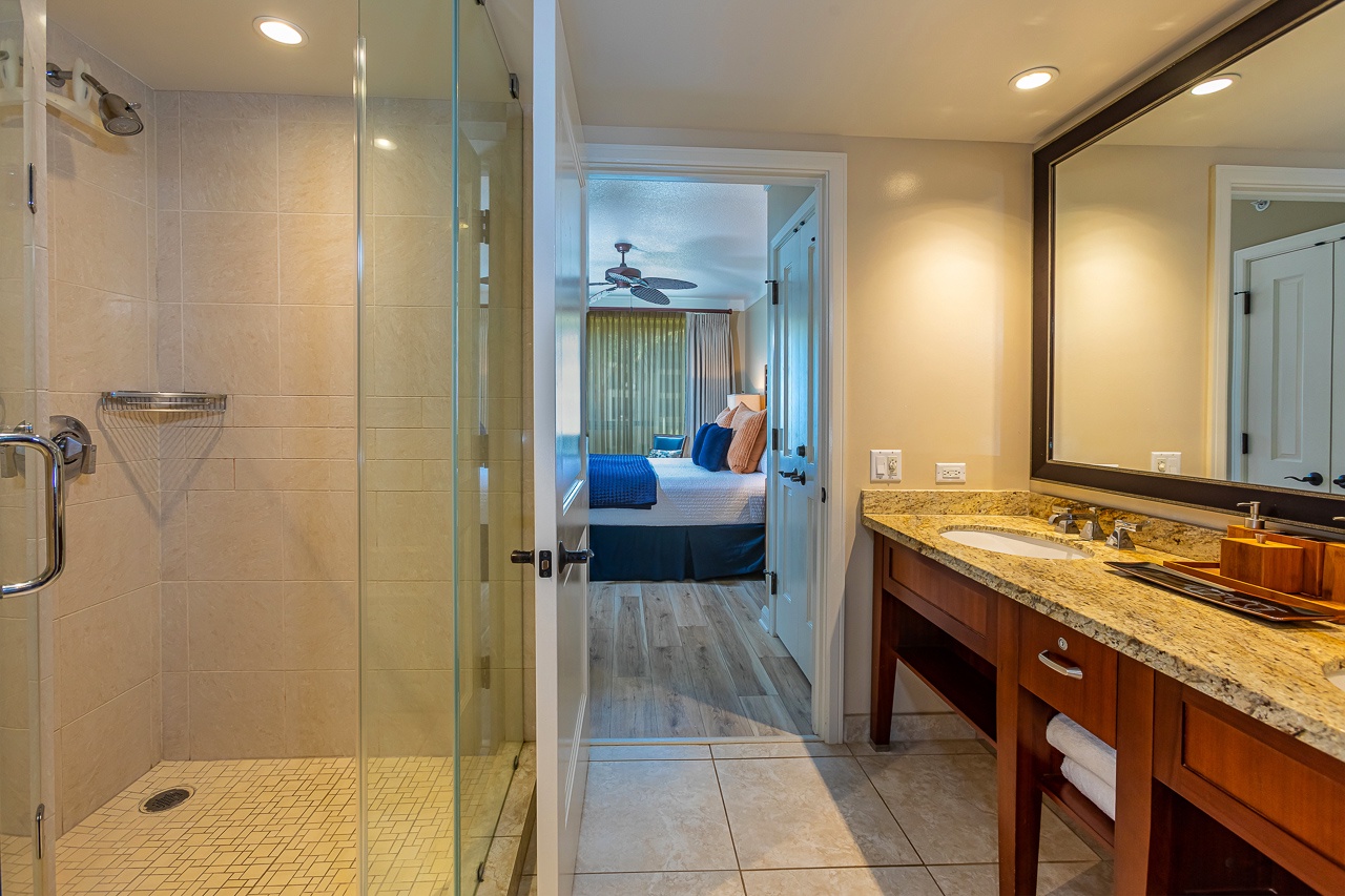 Your private bathroom features a spacious walk-in shower and soaking tub, connecting seamlessly to your guest bedroom retreat.
