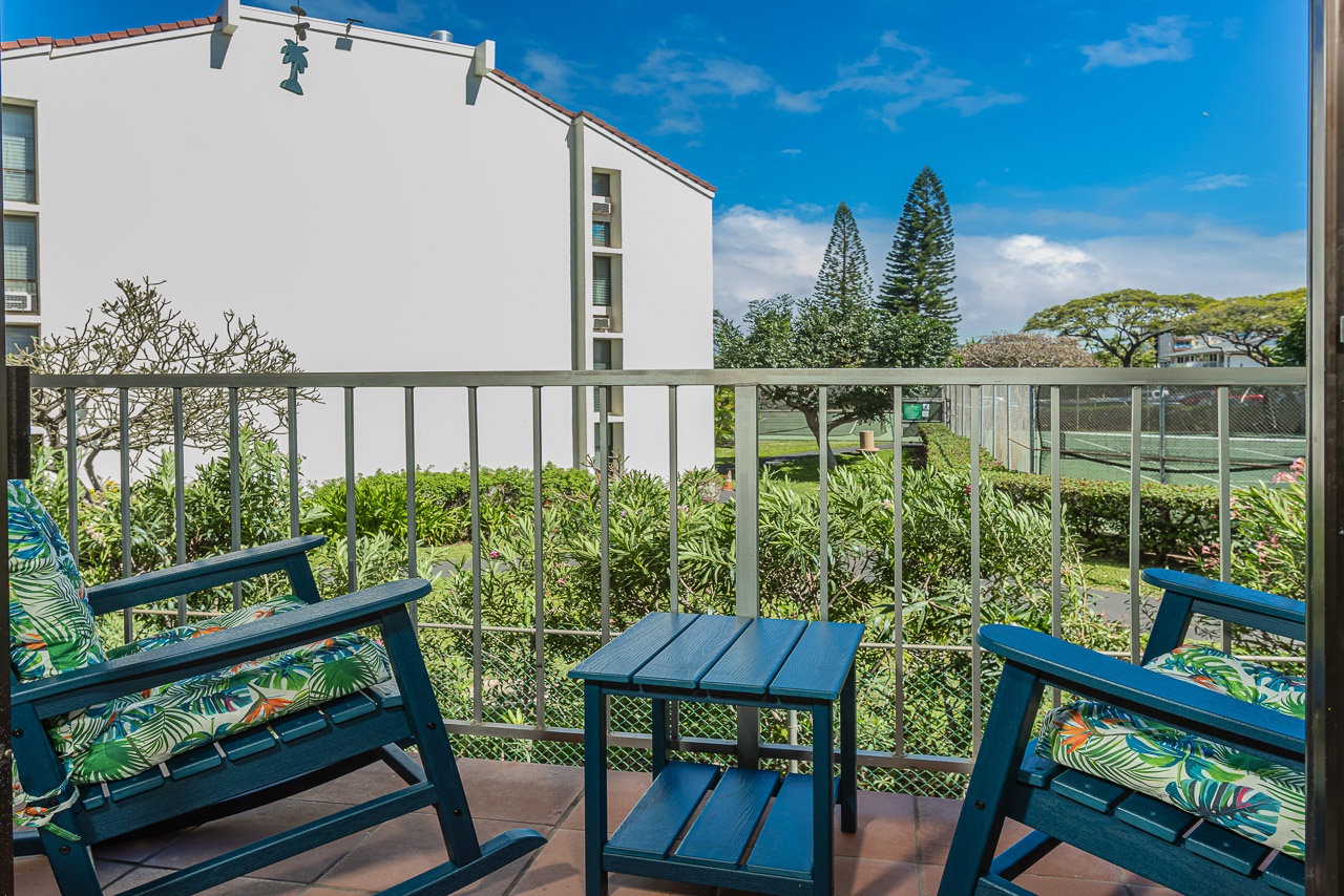 Sip your morning coffee on this charming balcony, where tropical cushions and garden views create your perfect retreat.