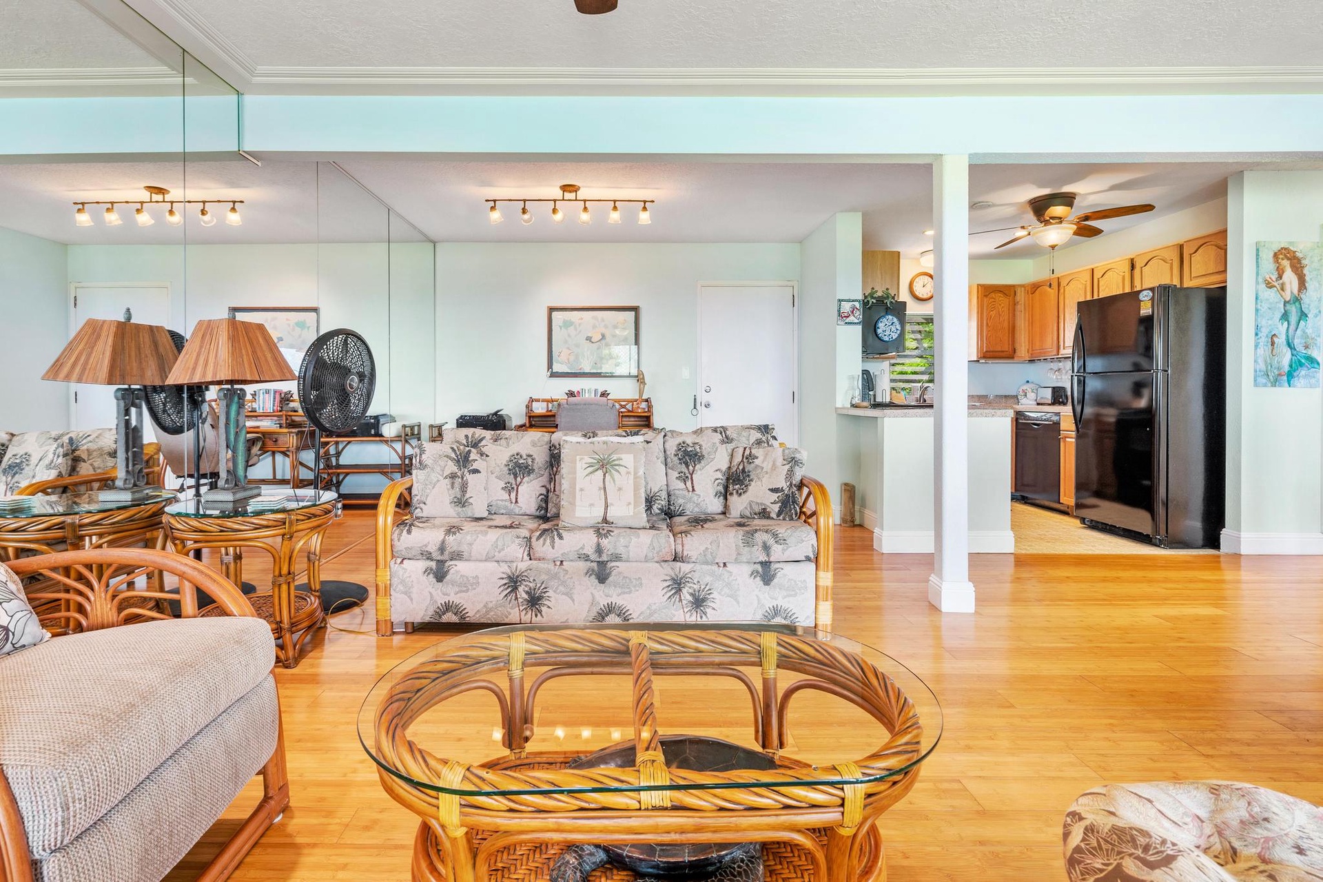 Relax in your tropical-themed living space with gleaming hardwood floors, coastal decor, and an open kitchen perfect for vacation meals.