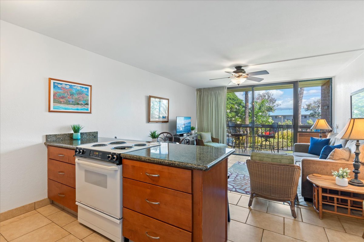 Step into your island retreat where the kitchen flows seamlessly into the living space, and ocean breezes drift through open doors to your private balcony. Natural light and coastal charm fill every corner.