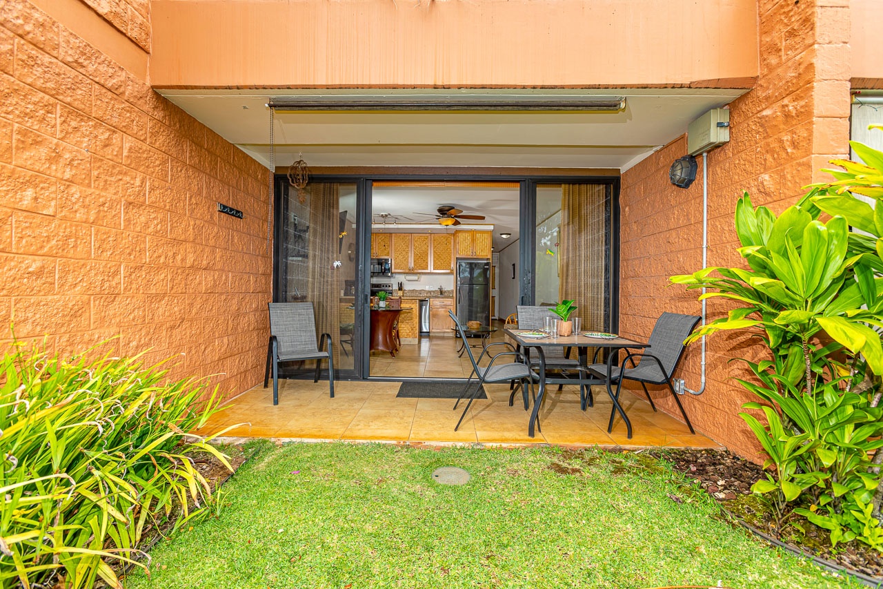 This private patio offers your perfect blend of indoor-outdoor living, with a cozy dining spot, lush greenery, and seamless access to your fully equipped kitchen.