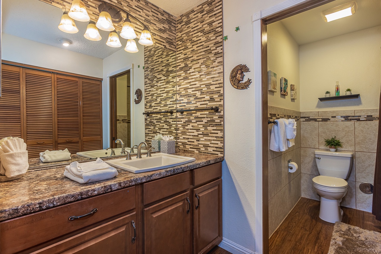 Refresh in your spa-inspired bathroom featuring mosaic accent walls that creates a luxurious retreat.