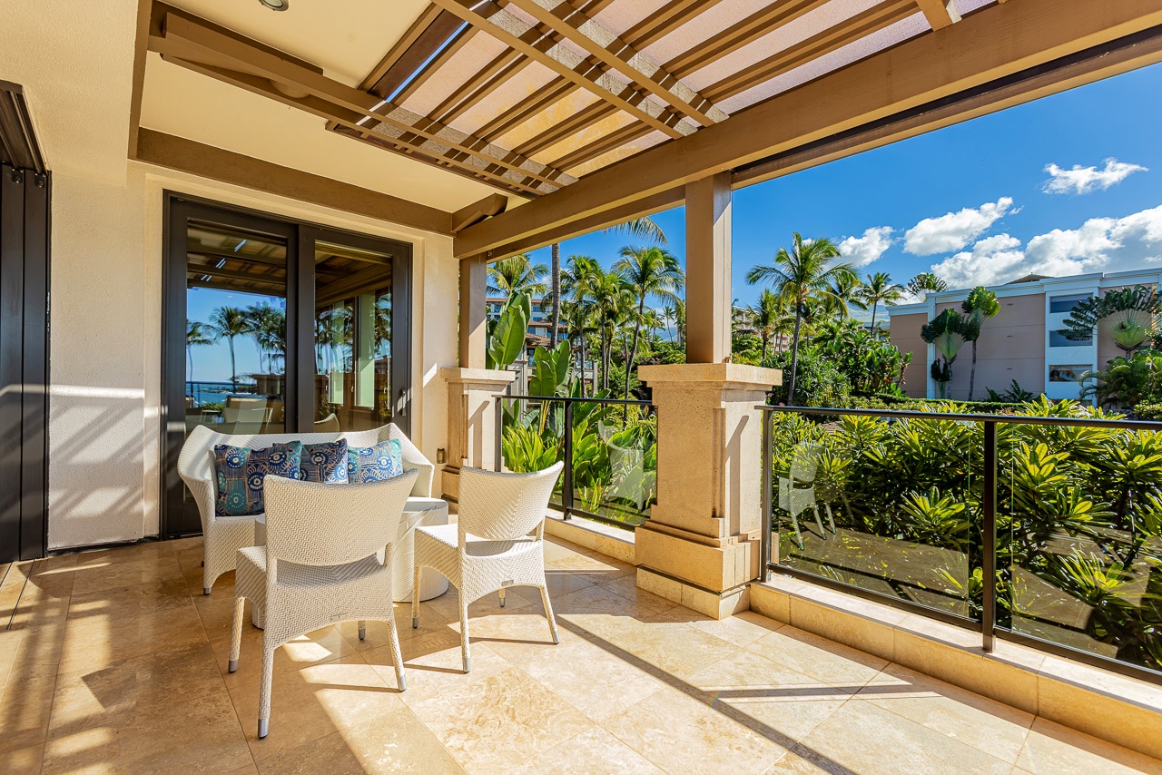 Your private lanai invites you to unwind beneath a sun-dappled pergola, where tropical breezes and vibrant garden views create the perfect escape for morning coffee or sunset relaxation.