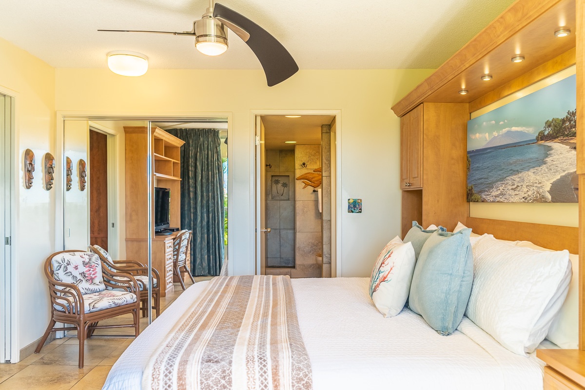 Unwind in your peaceful island retreat with coastal views framed above the bed, a cozy seating nook, and an ensuite bathroom just steps away for ultimate comfort.